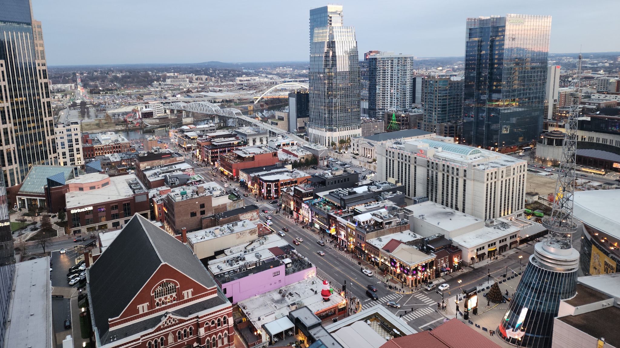 Lower Broadway, Bridgestone Arena and the river bridges seen from above in daylight.