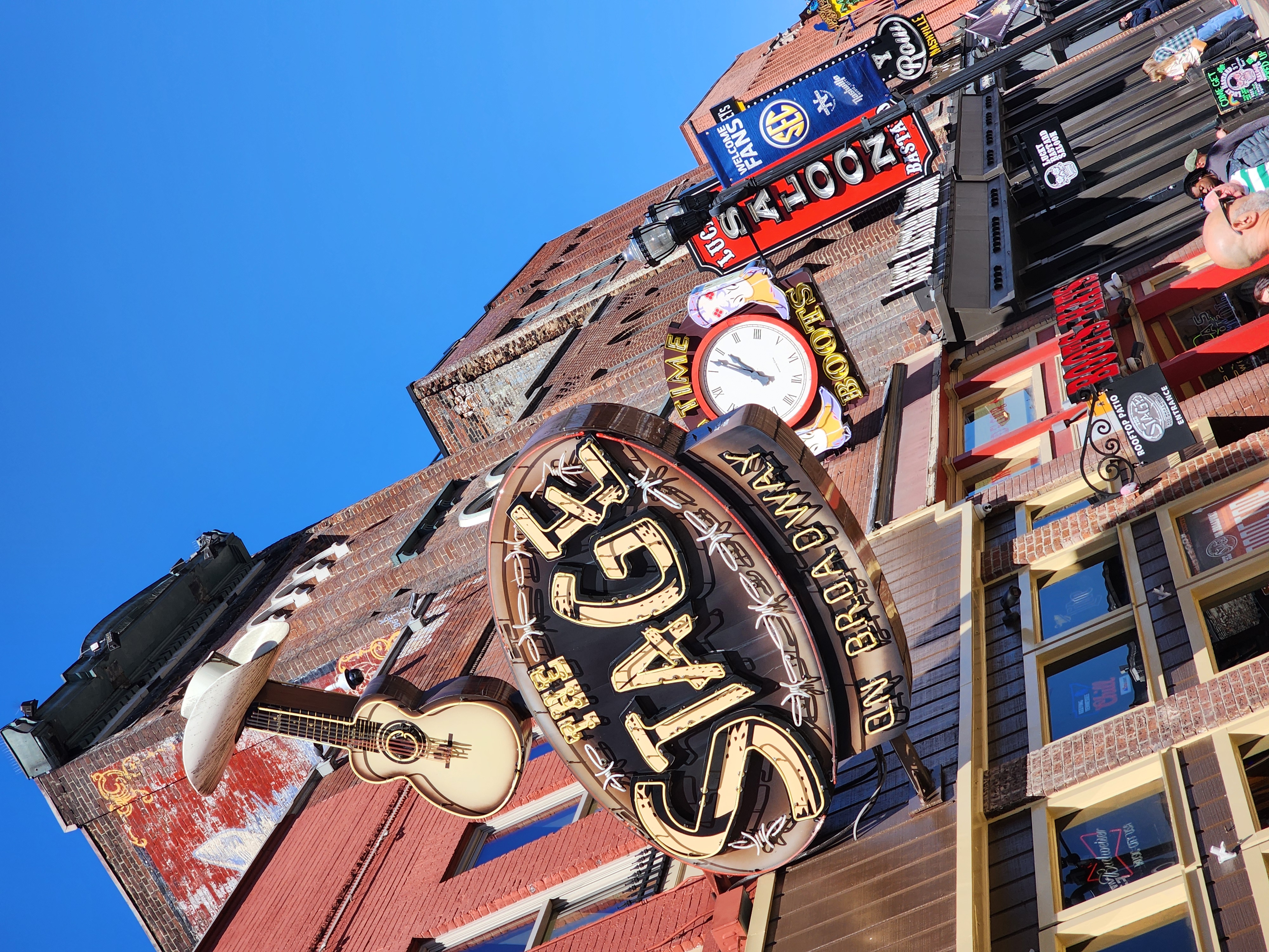 Signs for celebrity-owned bars rise above Lower Broadway in Nashville.